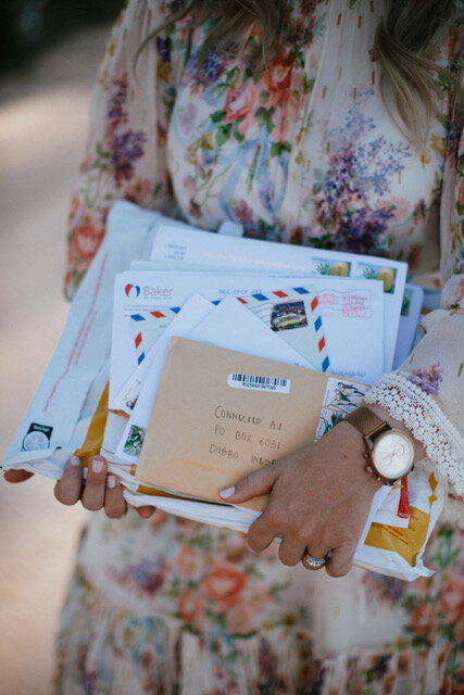 An armful of letters for the Letterbox Project, addressed to Connected AU